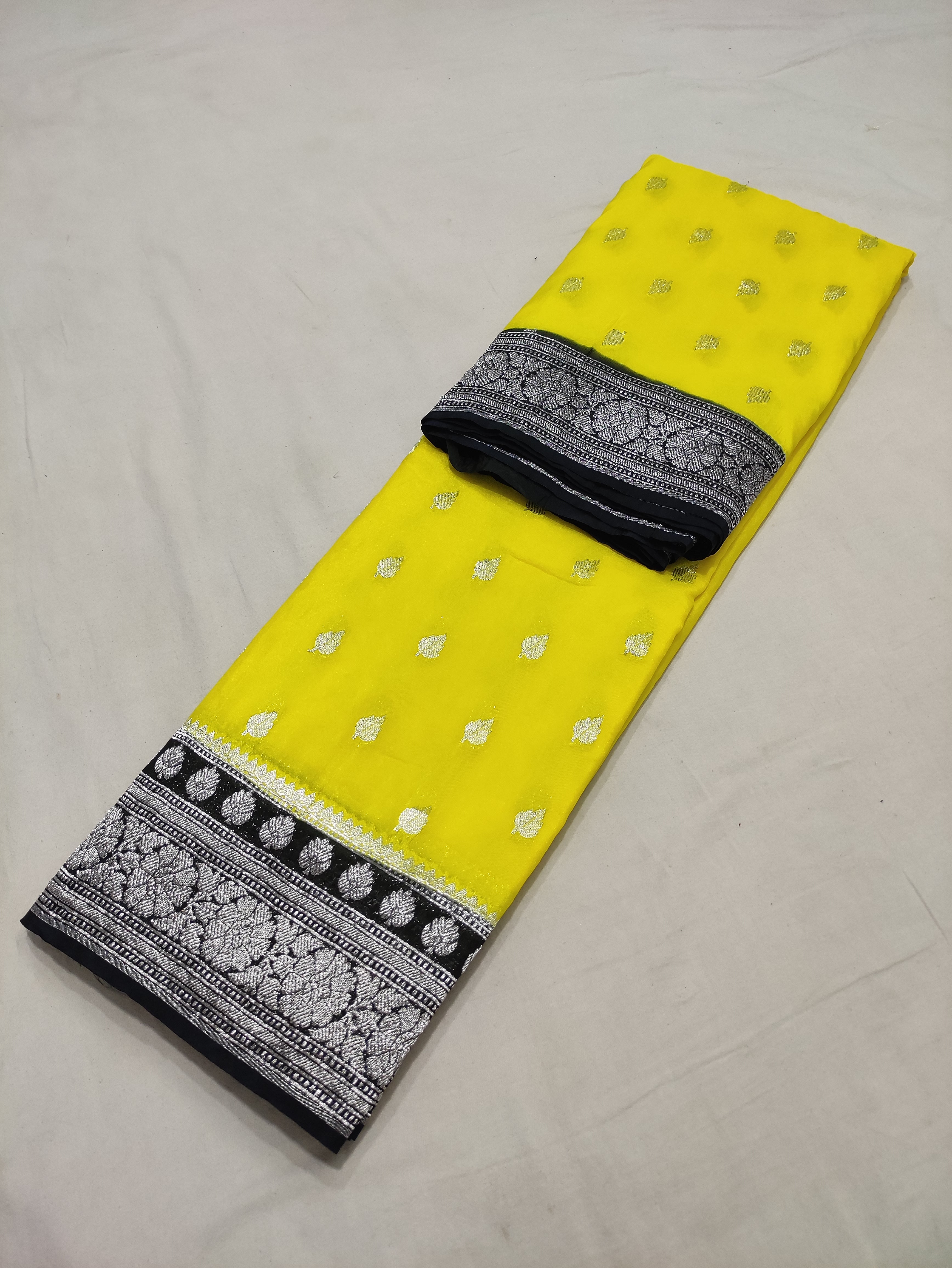 Lemon And Black Colour Zari Buti Georgette Saree